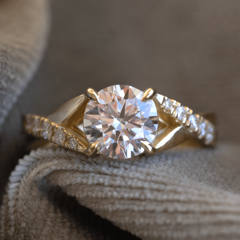 gold engagement ring on fabric 768x768